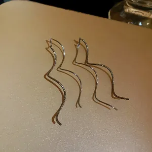 Detailed view of wavy gold-plated ear lines showing smooth and textured strands