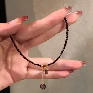 Macro view of vintage black crystal bead necklace with elegant gold-toned drop pendant