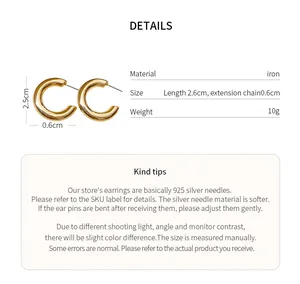 Detail view of golden C-shaped earrings with material and size specifications.