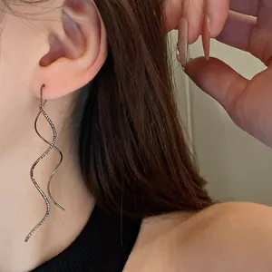 Close-up view of minimalist wave-shaped geometric long ear thread earrings for women