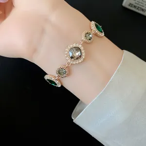 Bracelet élégant en plaqué or de style palais rétro avec strass verts et gris