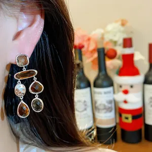 Elegant silver post dangle earrings with brown glass droplets for a vintage look.