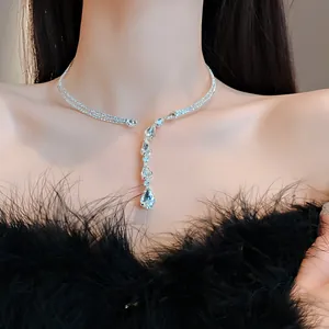 Close-up macro view of sparkling zircon water-drop pendant on elegant silver-tone necklace