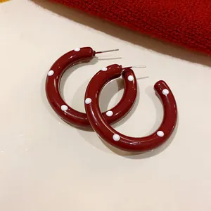 Retro vintage burgundy hoop earrings featuring white polka dots and durable steel pins.