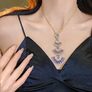 Detailed close-up of multi-layer fan pendant necklace with purple crystals on model