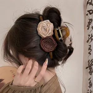 Elegant Maillard style acrylic hair claw clip with double fabric rose flowers shown on model