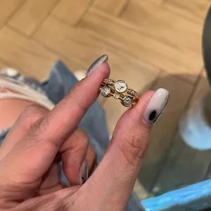 Close-up of vintage style double-layer gold ring with zircon and portrait engraving