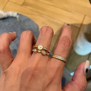 Detailed close-up showing a vintage gold double-layer open ring with zircon and coin motifs
