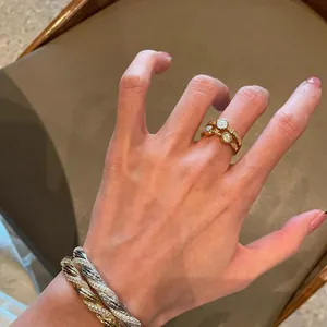 Close-up detail of a vintage style gold double-layer zircon open ring worn on finger