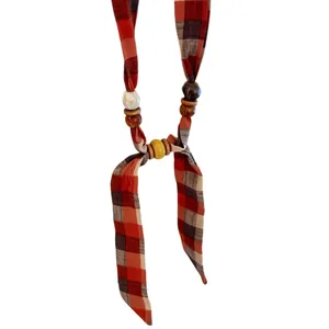 Handmade retro ethnic necklace featuring red plaid fabric with wooden and ceramic beads.