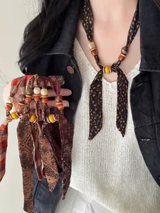 Macro view of vintage ethnic beaded chiffon scarf necklaces with unique patterns