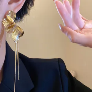 Elegant golden flower tassel earrings with vintage textured petals for stylish women