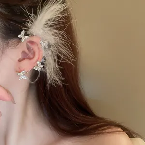 Elegant silver-toned rhinestone butterfly ear cuff with long white feather accents for women