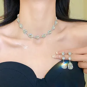 Close-up of elegant water drop rhinestone necklace and matching earrings worn by a model