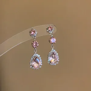 Detailed view of pink water-drop crystal earrings with sparkling rhinestone border