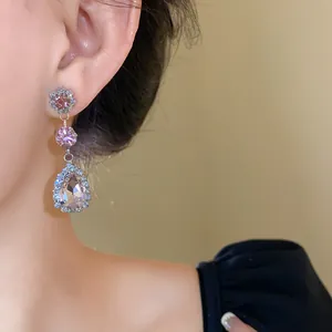 Detail view of pink rhinestone water drop dangle earrings with elegant crystals