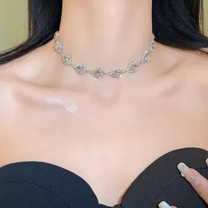 Detailed macro shot of a sparkling teardrop rhinestone necklace on elegant collarbone