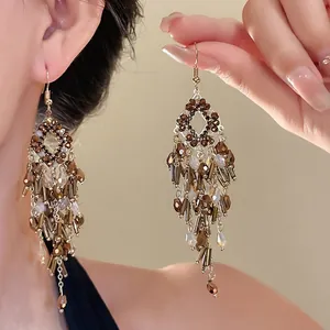 Elegant vintage bohemian chandelier earrings with brown crystals and golden tassel fringe