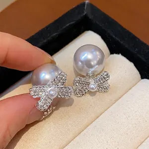 French retro bowknot stud earrings with sparkly rhinestones and elegant pearls.