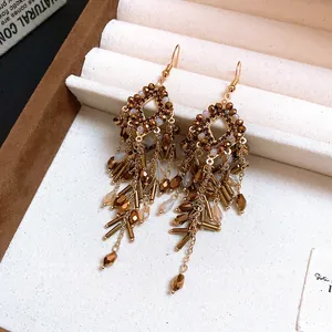 Elegant vintage bohemian style chandelier earrings with brown beads and gold tassel chains