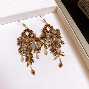 Vintage gold-toned bohemian dangle earrings with multi-layered beaded tassels and tubes