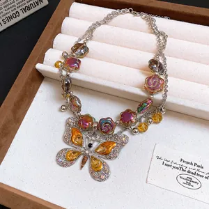 Detail view of a vintage multi-layer butterfly pendant necklace with floral beads