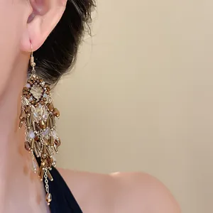 Detailed view of vintage bohemian chandelier earrings with brown crystal beads and tassels
