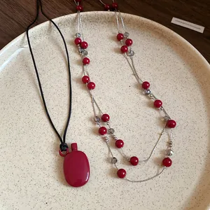 Close-up of retro red canteen pendant and elegant beaded double-layer necklace set