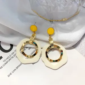 Elegant French style drop earrings with yellow studs and cream wavy rings for women