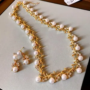 Luxurious French-style gold necklace and earring set with faux pearls and rhinestones