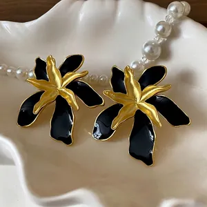 Vintage oversized black enamel flower stud earrings with matte gold petals