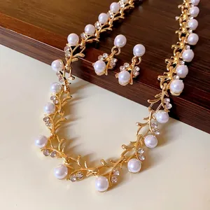Elegant faux pearl and rhinestone necklace and earrings jewelry set in gold finish