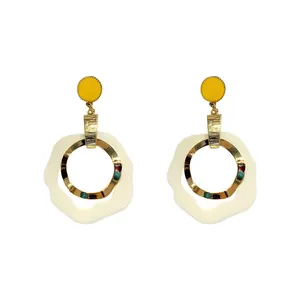 Elegant French style long drop earrings with yellow studs and gold wavy rings.