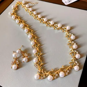Detailed macro view of French style pearl necklace and earring set with rhinestones