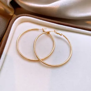 Nahaufnahme von großen minimalistischen goldenen Creolen in einer luxuriösen Schmuckschatulle