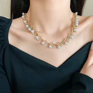 Detailed macro shot of elegant French style faux pearl and rhinestone necklace on model