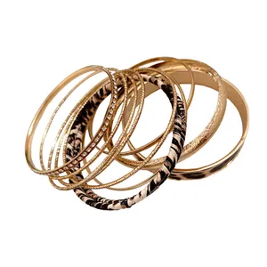 Vintage style stacked set of leopard print and gold metal bangles with rhinestone detail