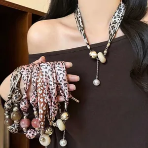 Leopard print fabric necklace with elegant pearl drop and vintage beads