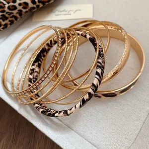 Detailed macro view of a vintage leopard print and gold textured metal bangle set