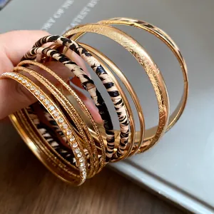 Detailed close-up of retro metal and leopard print leather bangles set for women