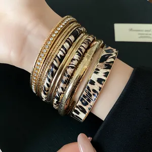 Detail shot of vintage leopard print and gold metal stacked bracelet set for women