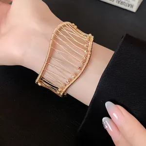 Close-up view of a French vintage gold woven mesh cuff bracelet with hollow pattern