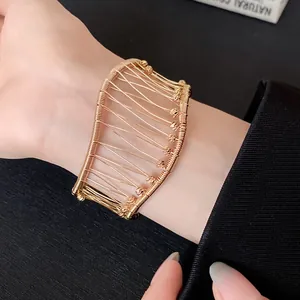 Elegant detail view of a French vintage gold woven mesh open bangle worn on a wrist