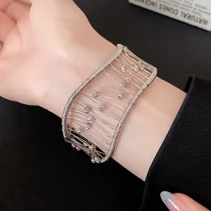 Close-up of a French vintage woven hollow mesh silver cuff bracelet on wrist