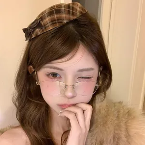 Close-up of sweet retro brown plaid beret hair clip worn by model for winter hair styling.