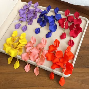 Detailed close-up of colorful Bohemian petal tassel earrings displayed in a beige jewelry box