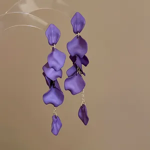 Detail of bohemian purple flower petal tassel earrings with matte finish and silver needle.