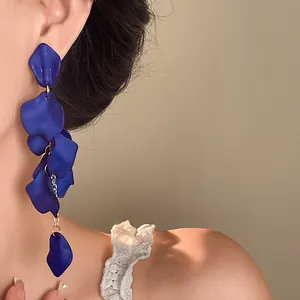 Macro view of blue petal tassel earrings showing delicate texture and cascading design