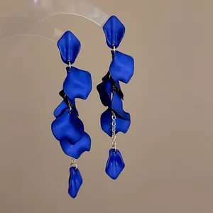 Close-up of bohemian blue petal tassel earrings with matte finish and gold-toned chains