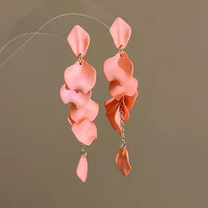 Close-up of pink petal tassel earrings with a matte finish and layered bohemian design.